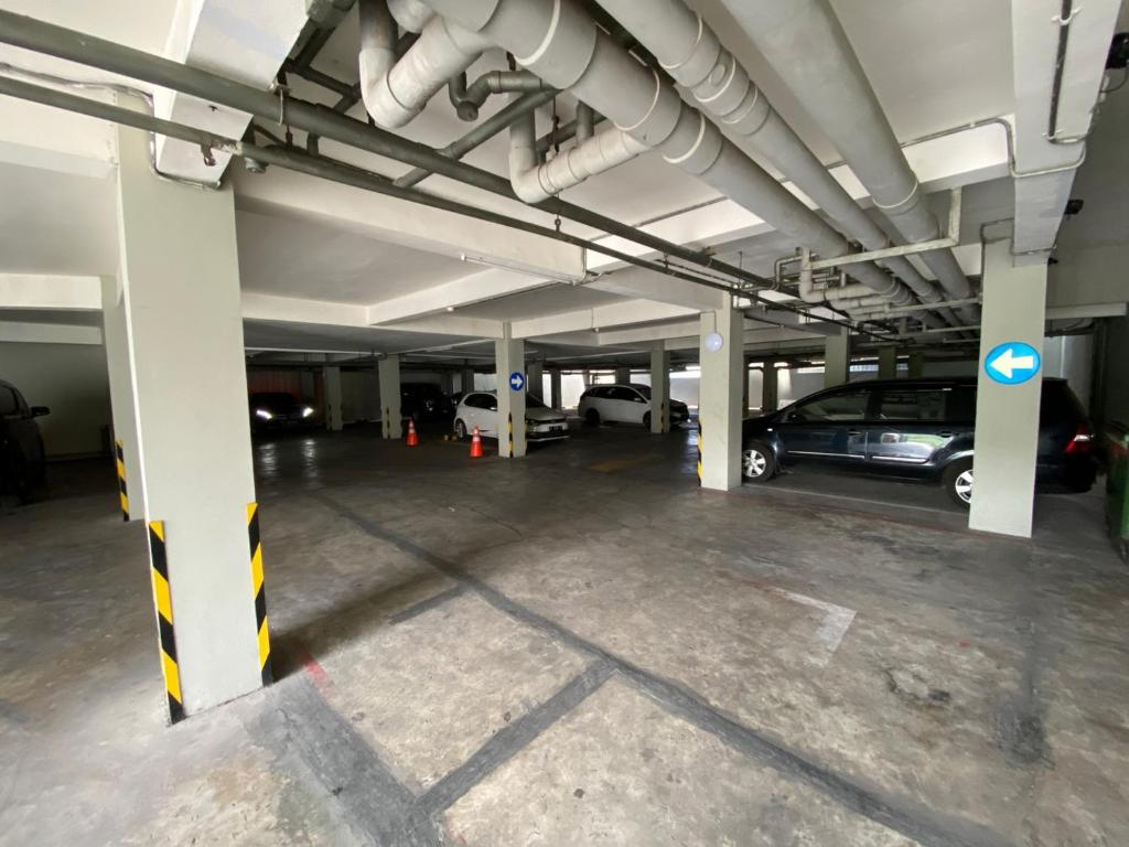 an empty parking garage with cars parked in it at FULMAR Pasteur in Bandung