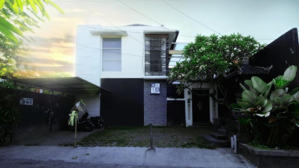 a white house with a black and white at Alia Home in Sanur
