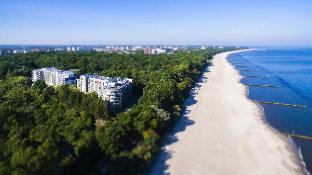 an aerial view of a beach with trees and buildings at 3L Apartments Diune in Kołobrzeg