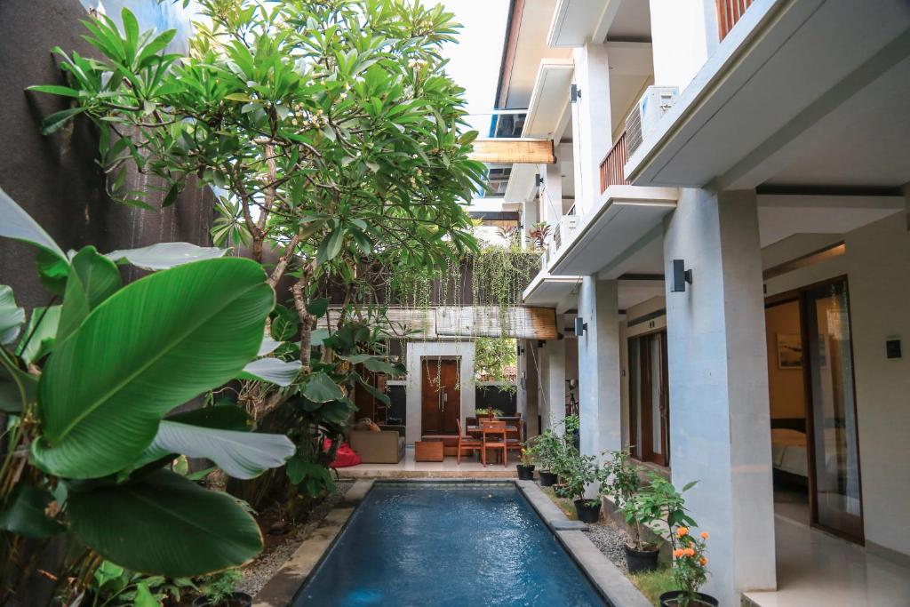 a courtyard with a swimming pool in a house at Alia Home in Sanur