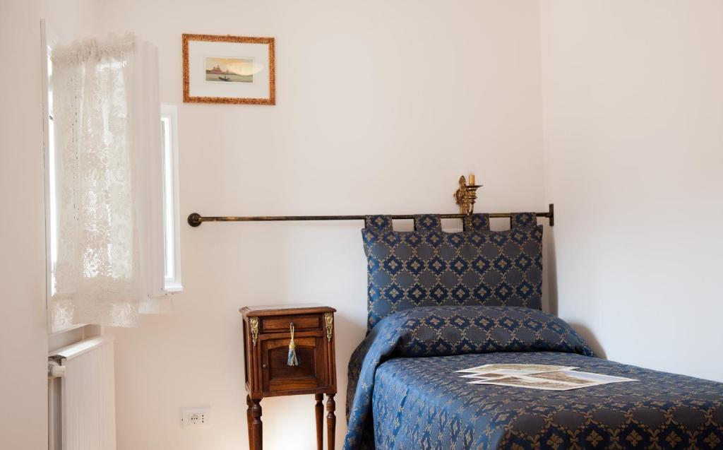 a bedroom with a bed and a table and a window at Ca Palazzo in Venice