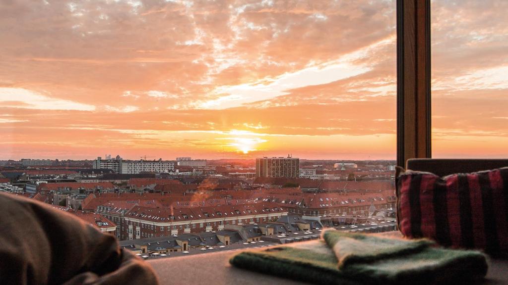 a view of a city at sunset from a window at Charlottehaven in Copenhagen