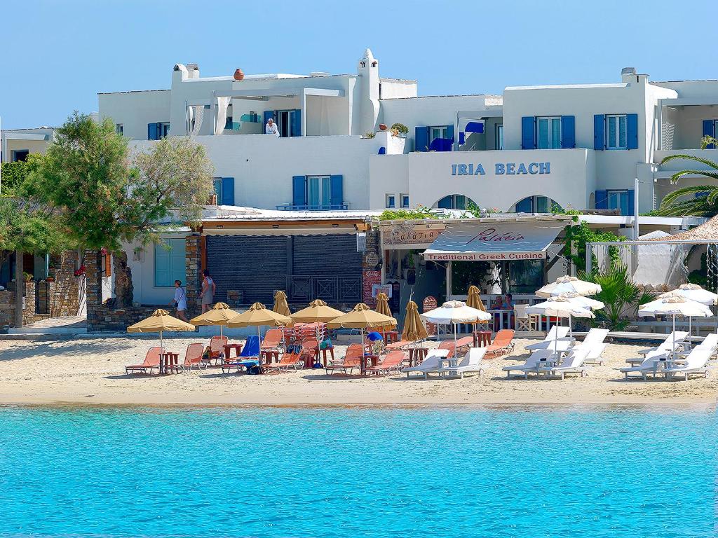 a group of chairs and umbrellas on a beach at Iria Beach Art Hotel in Agia Anna Naxos