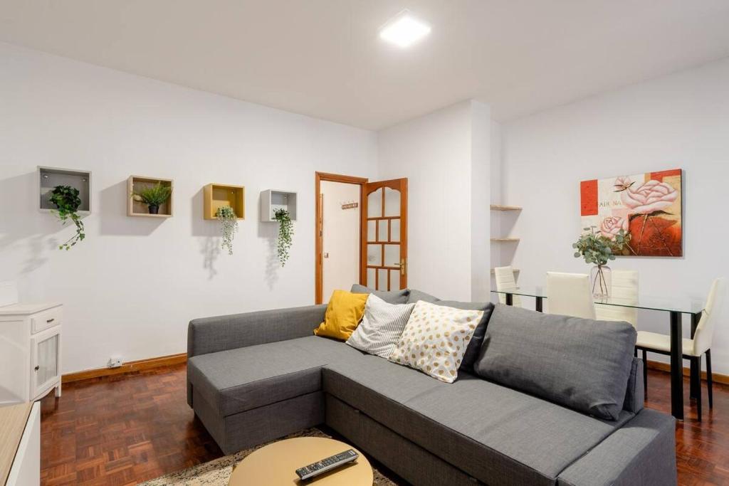 a living room with a couch and a table at Casa Andrea in Las Palmas de Gran Canaria