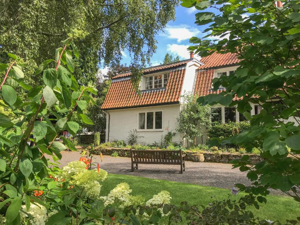 a bench sitting in front of a house at Branklyn Garden Cottage in Perth