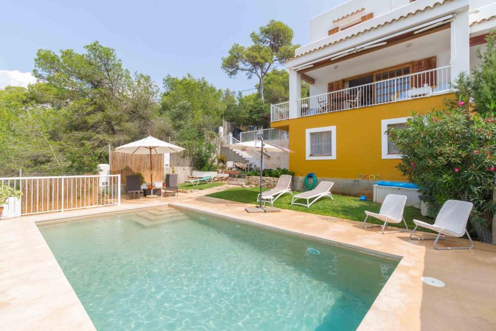 a swimming pool in front of a house at Casa Mar in Ibiza Town