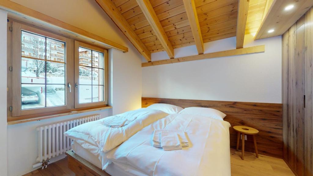 Postel nebo postele na pokoji v ubytování Haus Marietta - Leukerbad
