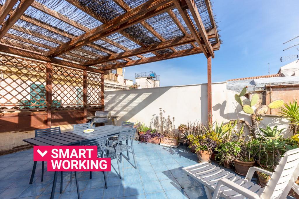 a patio with a table and chairs on a roof at Terrazze di San Francesco by Wonderful Italy in Palermo