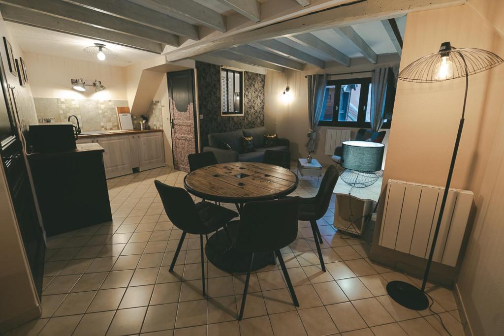 a kitchen and living room with a table and chairs at APPART Centre HISTORIQUE CHEZ RENÉ wifi in Troyes