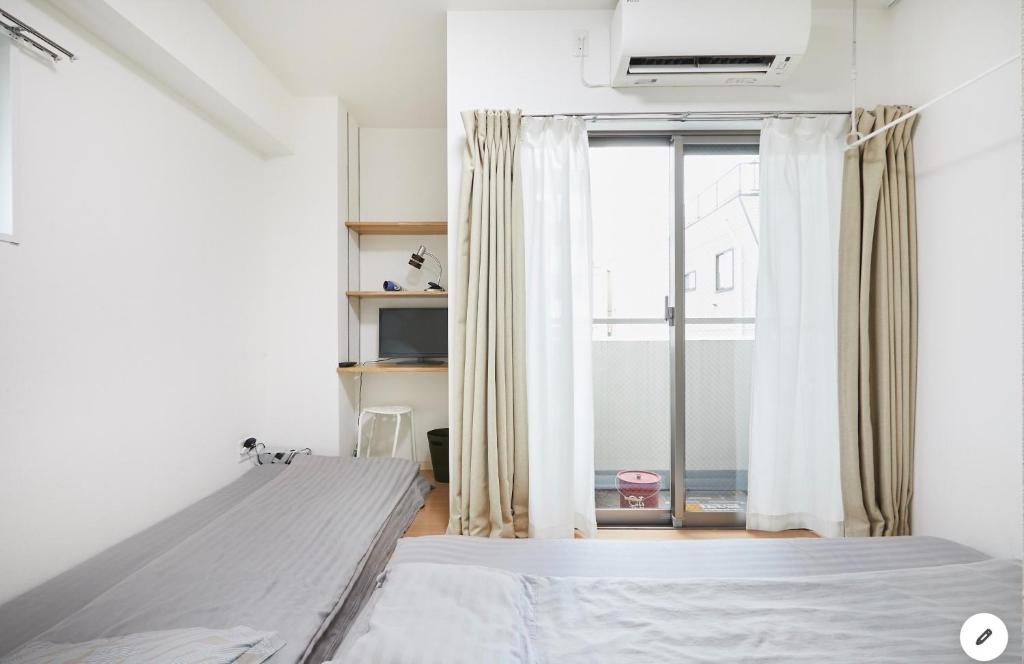 a bedroom with a bed and a window at Marvelous Kinshicho - Vacation STAY 12954v in Tokyo