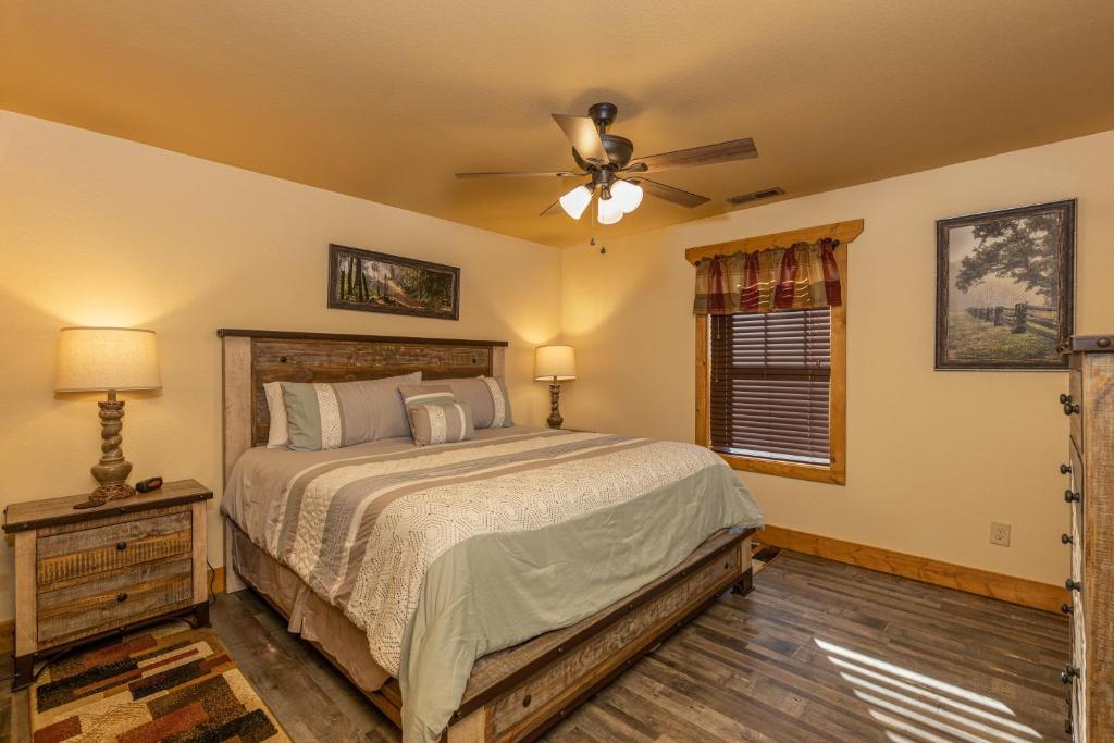 a bedroom with a bed and a ceiling fan at BearVue Point chalet in Gatlinburg