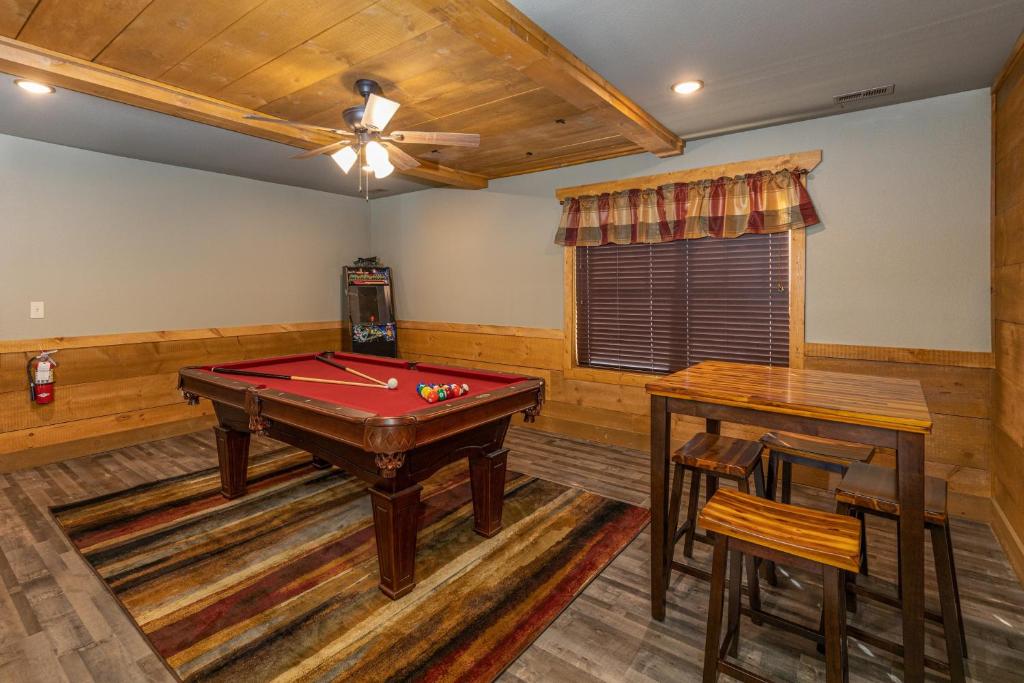 a billiard room with a pool table and two tables at BearVue Point chalet in Gatlinburg