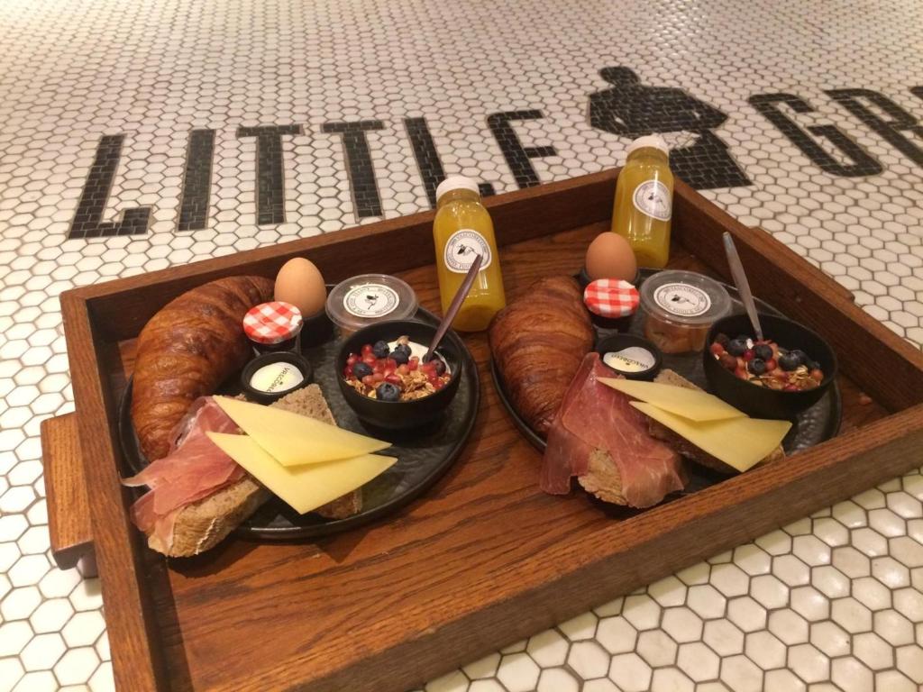 a tray of food with eggs and bread and cheese at Little Grand in Eindhoven
