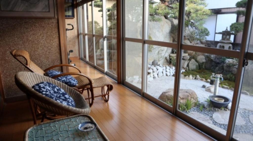 a room with a balcony with a view of a garden at Oyado Endo - Vacation STAY 12914v in Sanuki