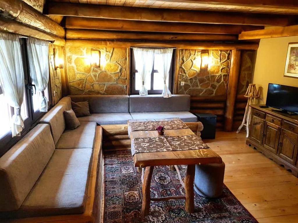 a living room with a couch and a table at Apartman Romanija Dolina mira in Pale