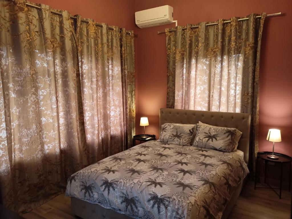a bedroom with a bed and some curtains at Studio in the center of Nicosia in Nicosia