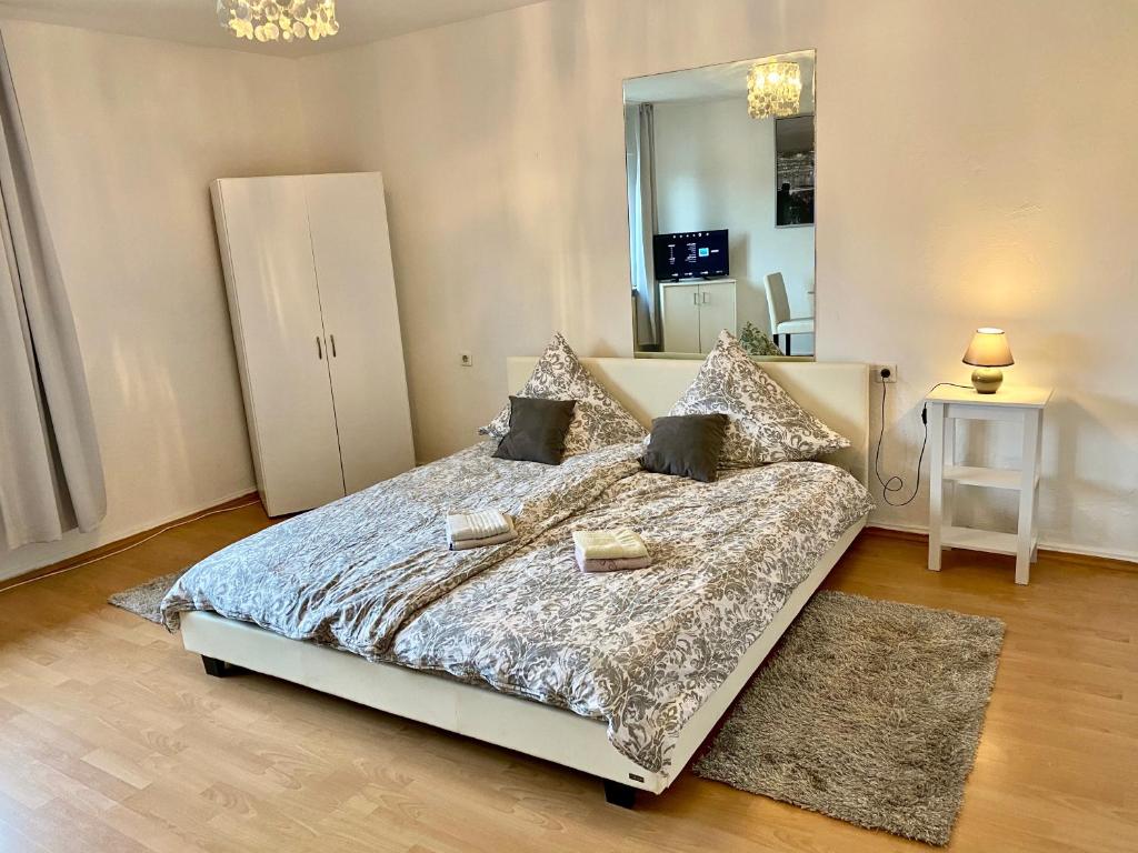 a bedroom with a bed and a mirror at Zentrales WG-Zimmer 3 in Ravensburg stadtnah in Ravensburg