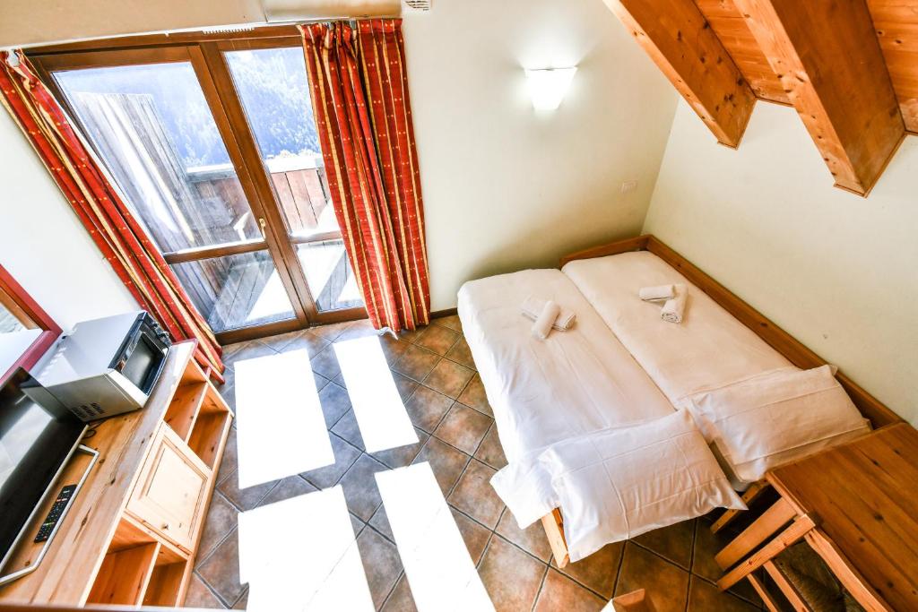Łóżko lub łóżka w pokoju w obiekcie Residence Stalle Lunghe