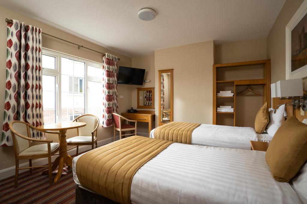 Postel nebo postele na pokoji v ubytování Belmore Court & Motel