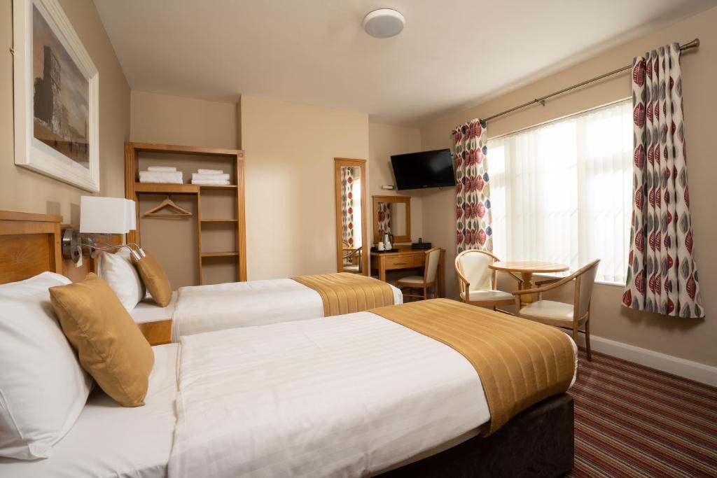 Postel nebo postele na pokoji v ubytování Belmore Court & Motel