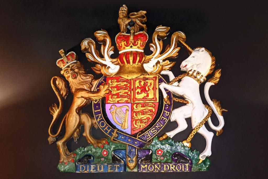 a gold and red crest with a horse on it at The Bells - Luxury Serviced Apartments in Leeds