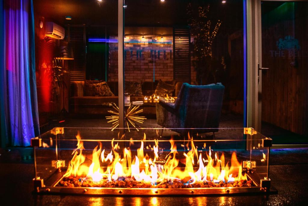 a fire pit in a living room with flames at The Bells - Luxury Serviced Apartments in Leeds