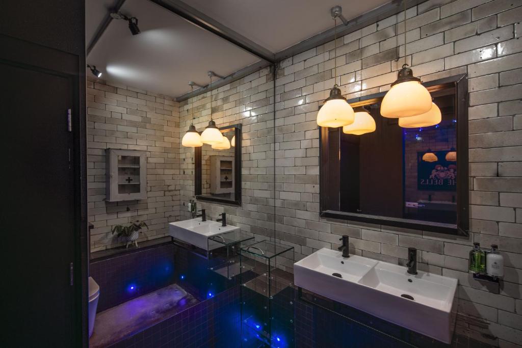 a bathroom with two sinks and a bath tub at The Bells - Luxury Serviced Apartments in Leeds