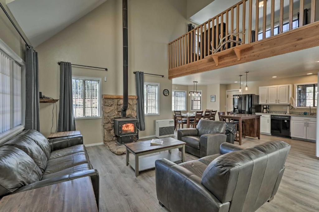 a living room with leather furniture and a fireplace at Spacious Family Home Surrounded by Mtn Views! in Flagstaff
