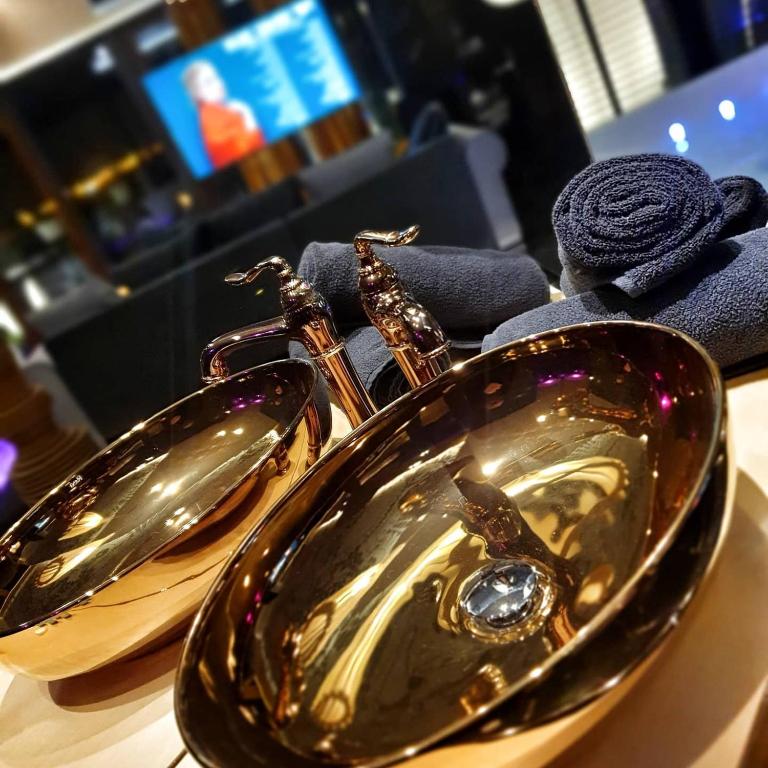 a pair of gold sinks on a table at Hotel Ramka & Restaurant & Wine Bar in Poznań