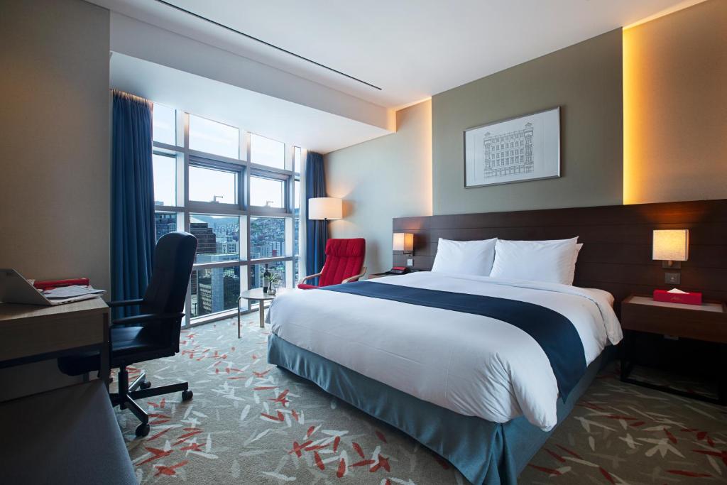 Postel nebo postele na pokoji v ubytování ASTI Hotel Busan Station
