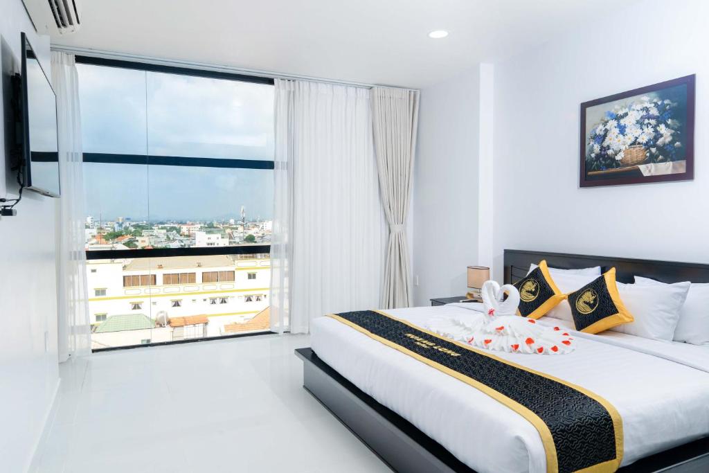 Giường trong phòng chung tại Hoang Long Hotel Phan Thiết