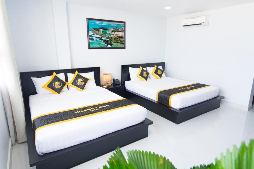 Giường trong phòng chung tại Hoang Long Hotel Phan Thiết