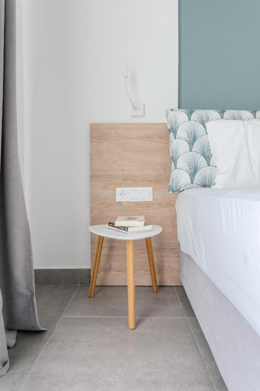 a bed with a table next to a bed at Mougre studios in Polychrono