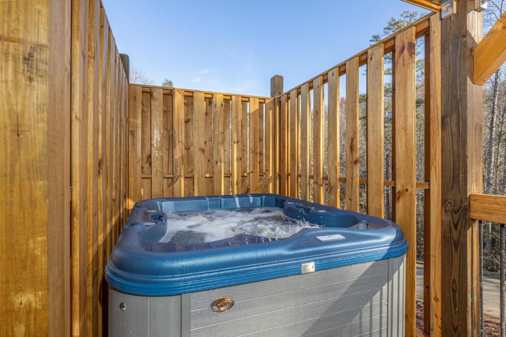 a hot tub sitting next to a wooden fence at BearVue Point chalet in Gatlinburg