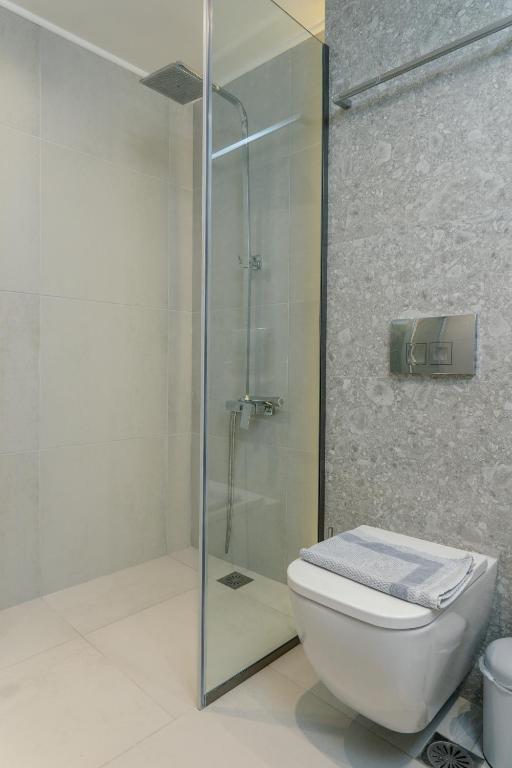 a bathroom with a glass shower and a toilet at Mougre studios in Polychrono