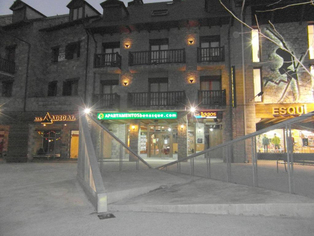 a building with a staircase in front of it at night at Apartamentos Los Lagos in Benasque