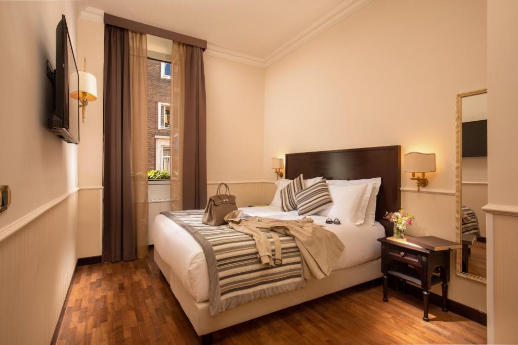 Postel nebo postele na pokoji v ubytování Hotel Del Corso