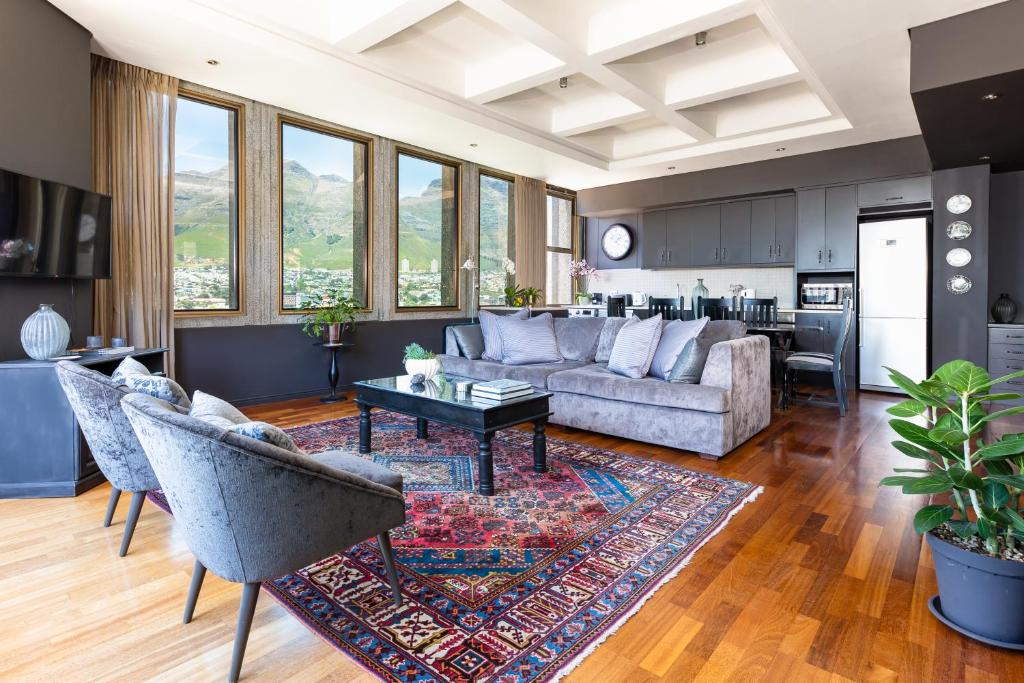 a living room with a couch and a table at #1701 Cartwright - Dark Glamour in Cape Town