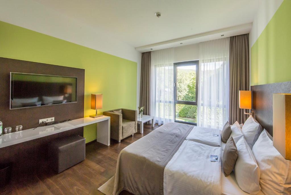 Postel nebo postele na pokoji v ubytování Hotel Im Schulhaus