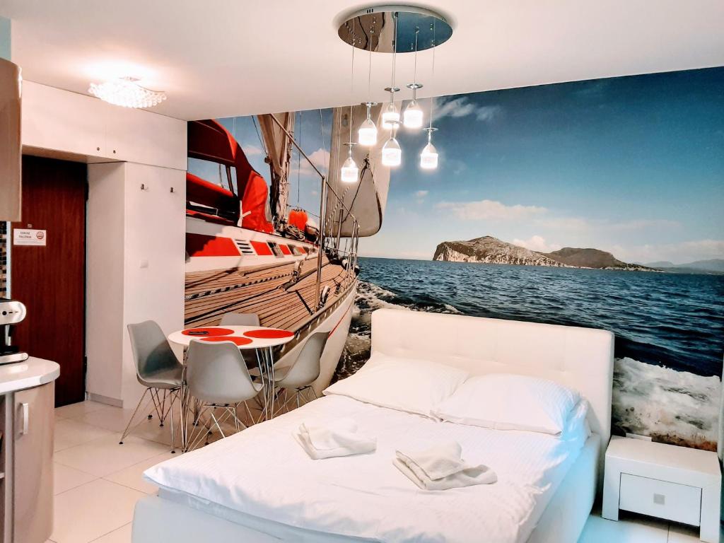 a bedroom with a bed and a view of the ocean at APARTAMENTY NADMORSKIE STEGNA BALTIC PARK in Stegna