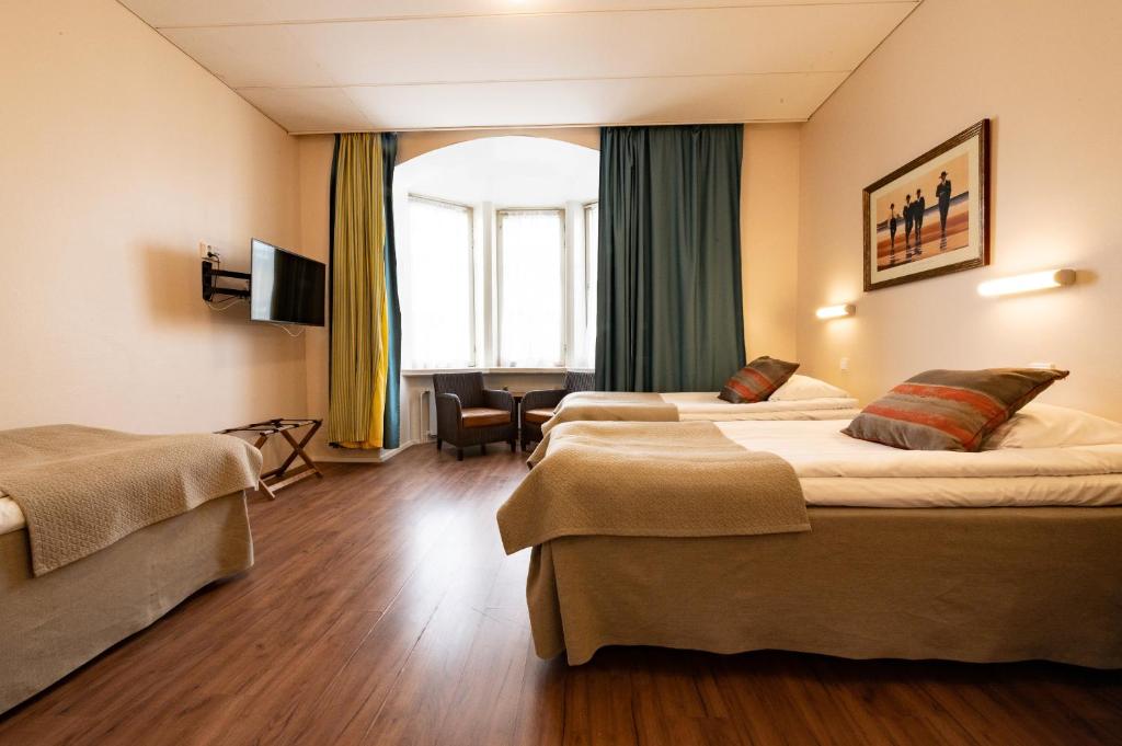 Postel nebo postele na pokoji v ubytování Hotel Arthur