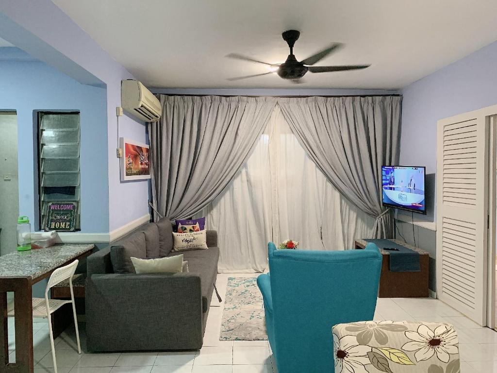 a living room with a couch and a ceiling fan at Condo D'Savoy @ Famosa, Malacca in Melaka