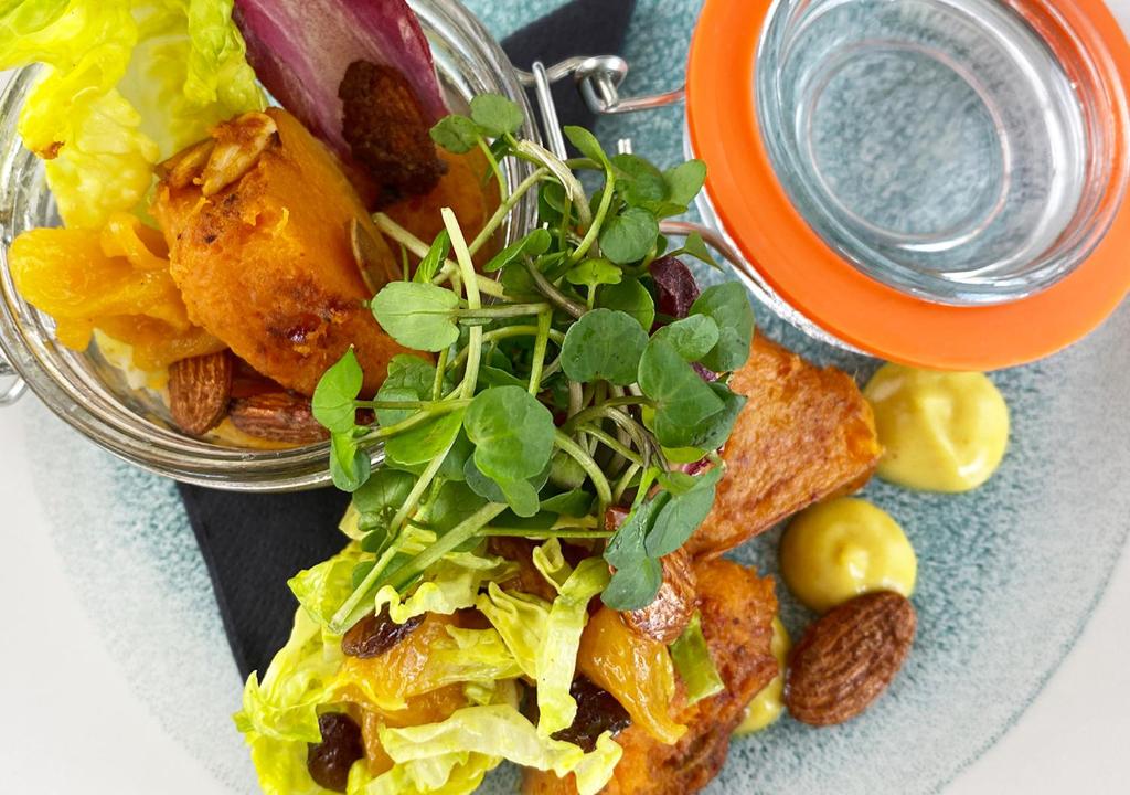 a plate of food with a salad and a drink at Harbour Heights Hotel in Poole