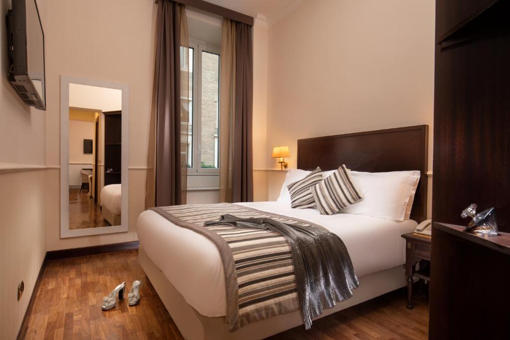Postel nebo postele na pokoji v ubytování Hotel Del Corso