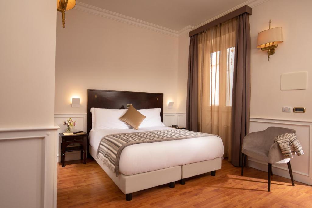 Postel nebo postele na pokoji v ubytování Hotel Del Corso