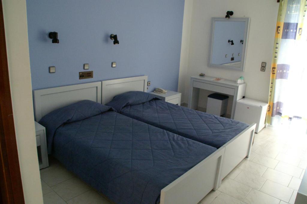 A bed or beds in a room at Ermioni Hotel