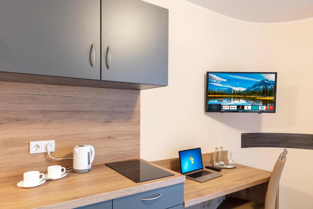 TV a/nebo společenská místnost v ubytování Dominik Hotel & Eventsaal