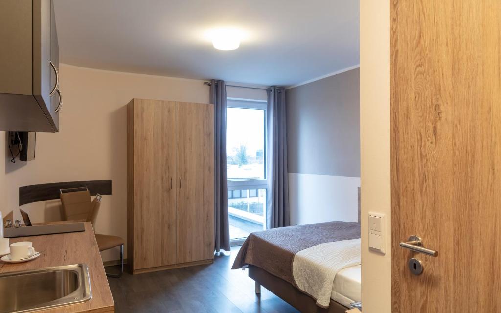 Postel nebo postele na pokoji v ubytování Dominik Hotel & Eventsaal