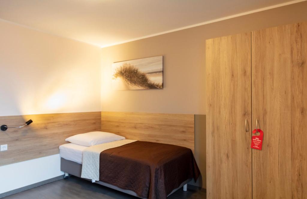 Postel nebo postele na pokoji v ubytování Dominik Hotel & Eventsaal
