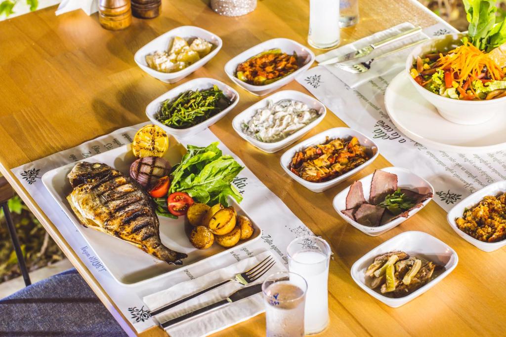 a table with many dishes of food on it at Hamarat Otel in Kaş